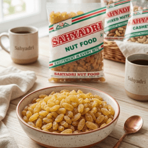 Sahyadrinuts premium golden raisins in a wooden bowl - high quality kishmish for Indian snacks.