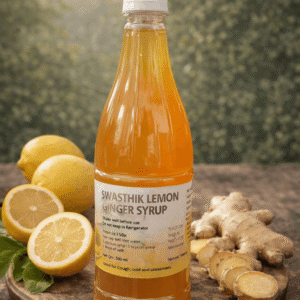 3-ingredient lemon ginger syrup bottle with fresh lemon halves and raw ginger root — natural Indian health drink.